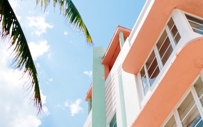 Image of white house with pastel orange and blue accents