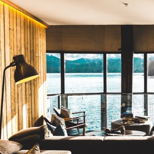 Image from inside of a lakehouse, with a view through the windows and onto the lake